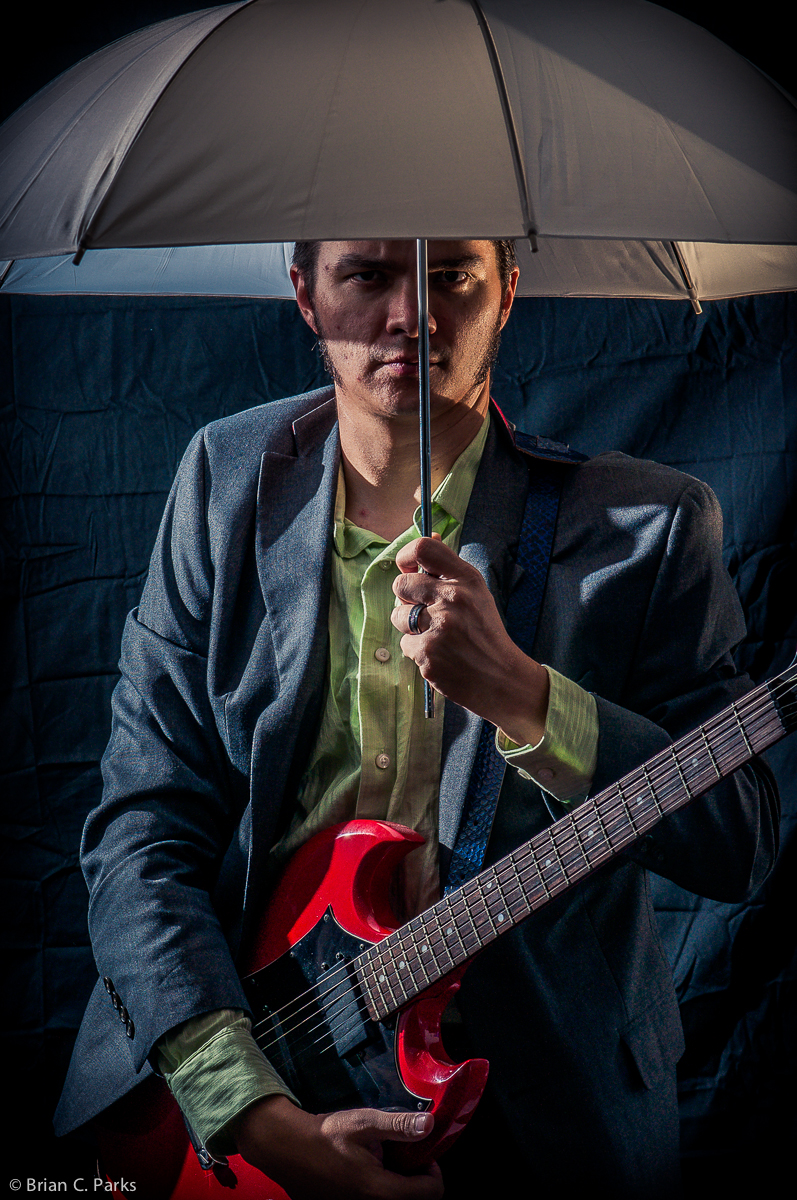 Self portrait with guitar and umbrella